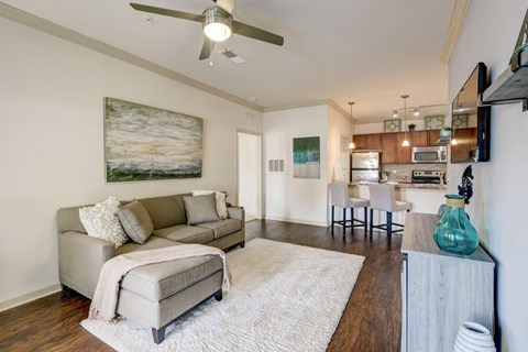 a living room with a couch and a ceiling fan